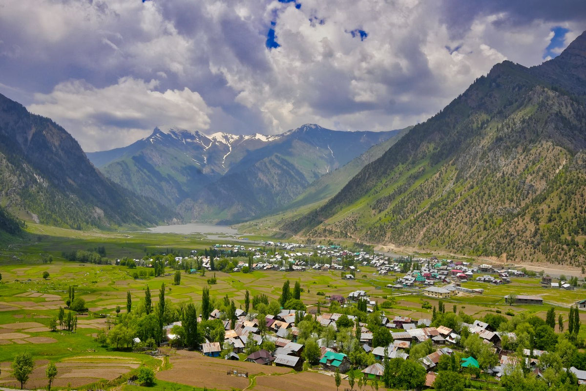 Kashmir valley with snow peaks and fields