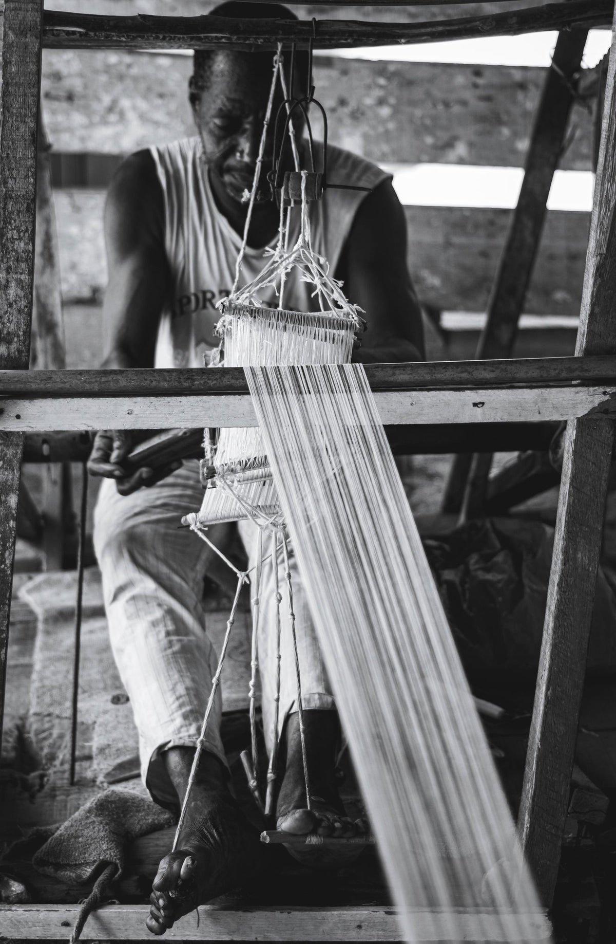 Weaver working at a wooden handloom